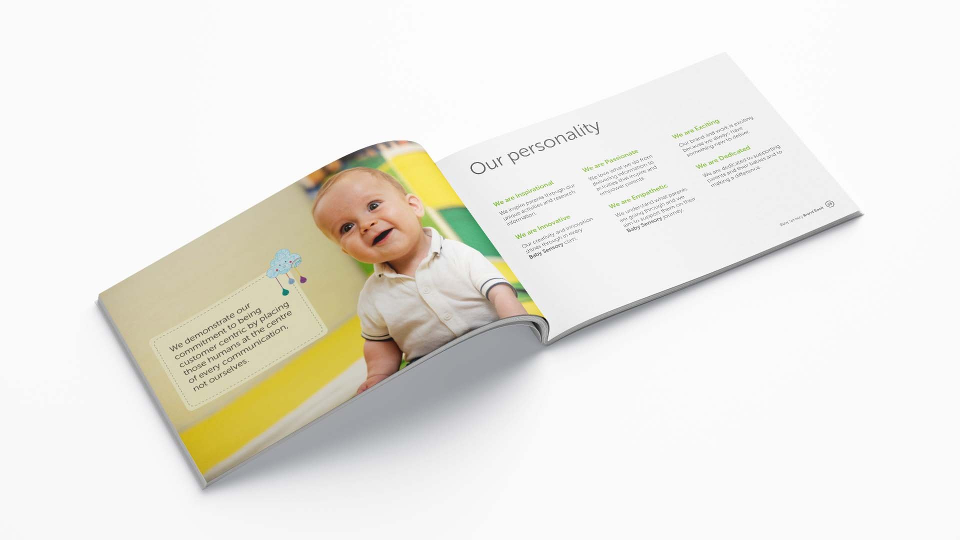Open booklet showing a happy baby on the left page and text about personality traits on the right page.